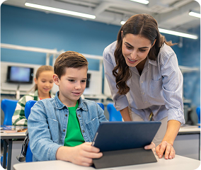 Teacher helping children with tablet